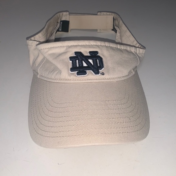 47 Other - One size tan with navy logo Notre Dame visor.